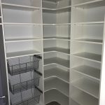 small closet with white shelving unit