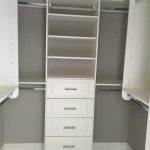 White shelving in grey closet