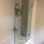 Shower tub combo with rounded glass door