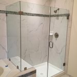 Glass door shower with marble tiles