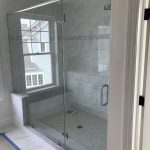 marble shower with glass enclosure