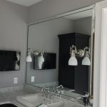 Corner view of mirror and sink in bathroom